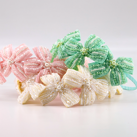 Designer Childrens Hair Bows handmade by Sienna Likes to Party Fashion Accessories for children.  The ultimate in luxury.  Each piece is hand stitched with hundreds of crystals and pearls.  The perfect special occasion hair piece for girls