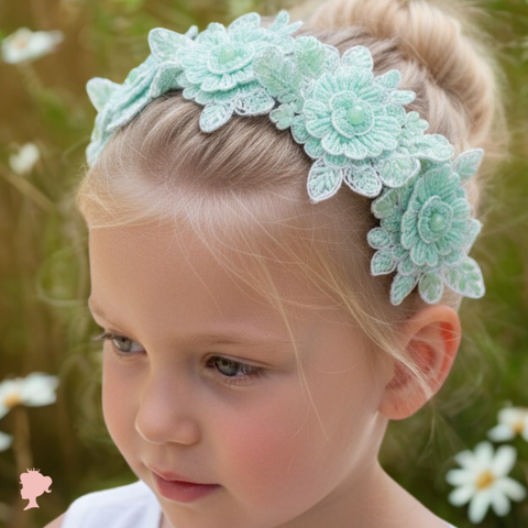Flower girl wearing a mint green floral hand headband lace headband perfect for. weddings, special occasions and childrens parties.
