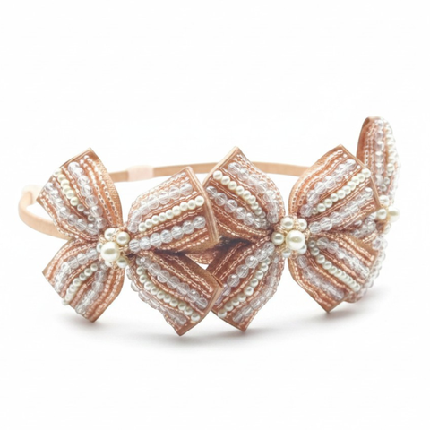 Designer blush crystal and pearl bow headband for girls, perfect for special occasionwear or flower girls - handmade by Saffron and Selene - specialists in luxury hand beaded hair accessories for kids.