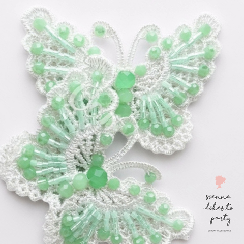 Hand beaded pastel mint green butterfly hair clip on white lace butterflies.  Handmade by Sienna Likes to Party - Luxury hair accessories for children