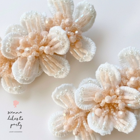 Hand beaded bespoke childs flower hair clip set.  White lace flowers embelished with pastel peach intricate beadwork.  Individually handmade by Sienna Likes to Party, luxury hair accessories for children.