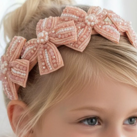 Designer Bow headband in soft apricot for girls by Sienna Likes to Party, hand embelished with crystals and pearls.
