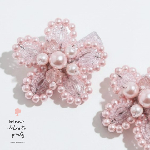 Bespoke handmade hair clip set for girls handmade with pink crystal and pearl beads creating two flowers. Hand beaded by Sienna Likes to Party Luxury hair accessories for children