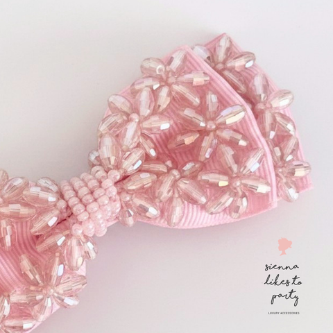 Close up of the hand beaded childrens pink bow hair clip created by Sienna Likes to Party - Luxury hair accessories for children