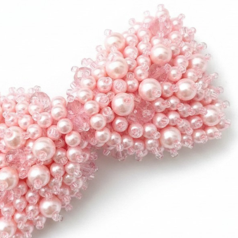 Close up of Luxury girls pink bow hair clip - hand beaded with pale pink pear and crystal beads.