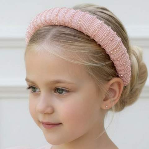 Luxury entirely hand beaded pale pink statement padded headband.  Encrusted with dozens of hand threaded crystal beads, perfect for childrens special occasions.  Designed. and Handmade by Sienna Likes to Party.