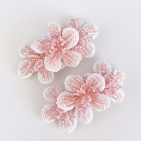 Girls handmade pink flower clip set.  A row of three white lace flowers, highly embellished with pastel pink handbeading.  Perfect for flower girls and childrens special occasionwear.