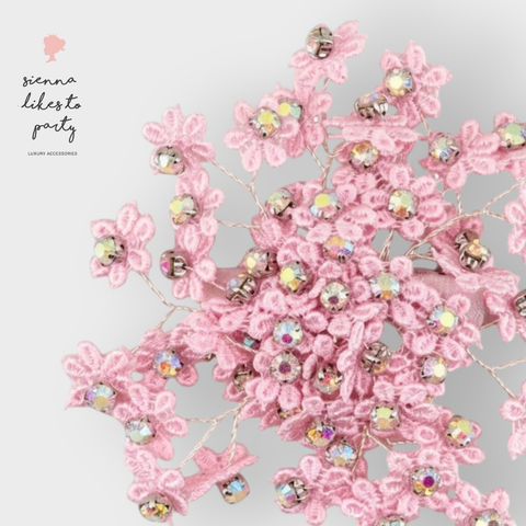 Close up of handmade childs floral lace hair clip in pastel pink, highly embelished with rainbow rhinestones for glamour and elegance by Sienna Likes to Party