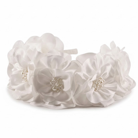 White floral headband with pearl accents on a white background
