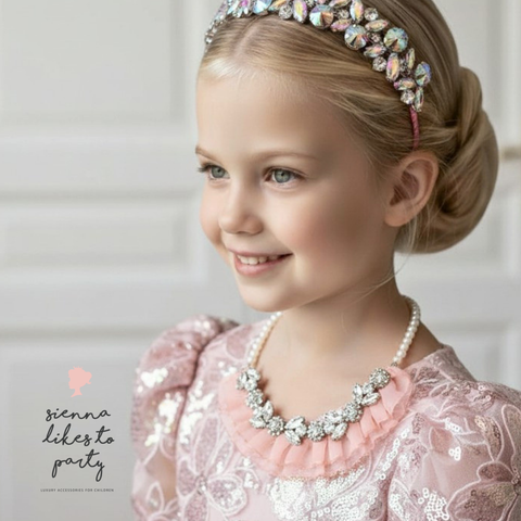 Model wears handmade rhinestone necklace with apricot chiffon frill detail and pearls, perfect for childrens special occasionwear.  Designed and created by Sienna Likes to Party - luxury accessories for children