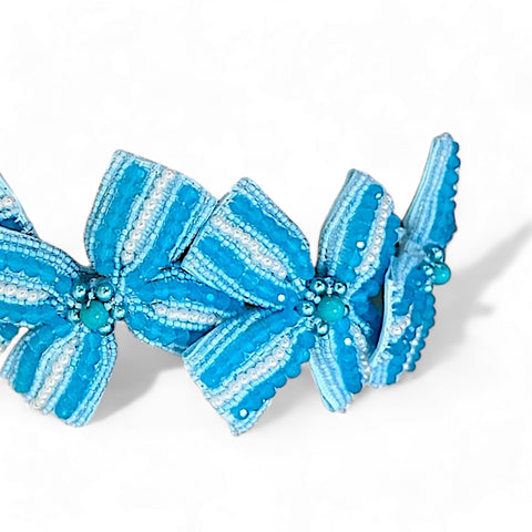 Designer handmade childrens hair accessories.  This bow headband is entirely hand beaded with turquoise blue crystals and pearls.  Designed by Sienna Likes to Party, luxury accessories for children