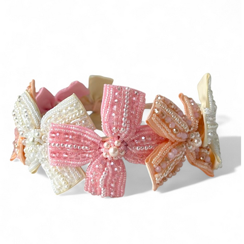 Girls Headband with handmade bows with beads, pearls, and crystals on a white background