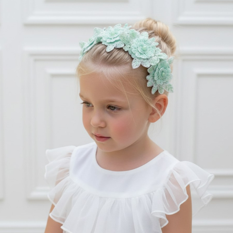 Young girl wearing a light  mint green hand beaded floral headband designed and created by Sienna Likes to Party luxury childrens hair accessories