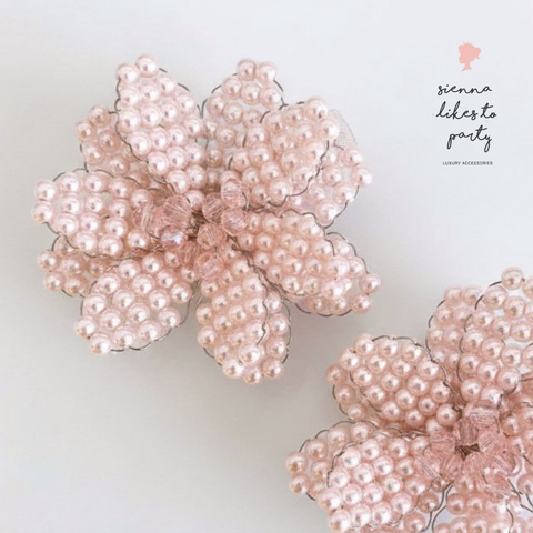 Close up Luxury kids pink flower hair clip set showing the hand beadwork using pink pearl beads and centered with pink faceted crystals.  Perfect for flower girls
