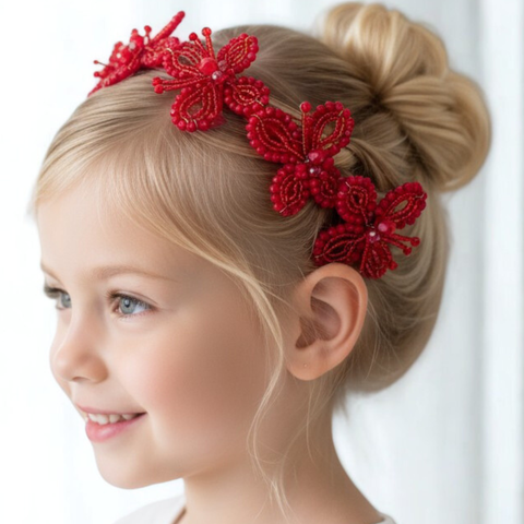 Young girl with blonde hair wearing a red butterfly hand beaded headband, the perfect festive kids hair accessory.