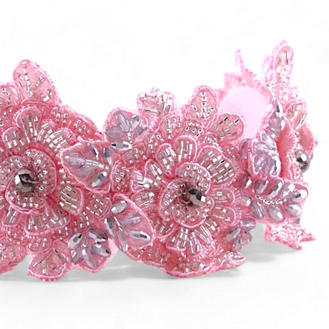 Close-up of the Hadraniel Crystal Flower Headband showcasing intricate pink lace flowers embellished with silver crystals and pearls