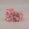 Handmade pink satin flower headband with crystal and pearl bead embellishments, perfect for weddings, birthdays, and special occasions.