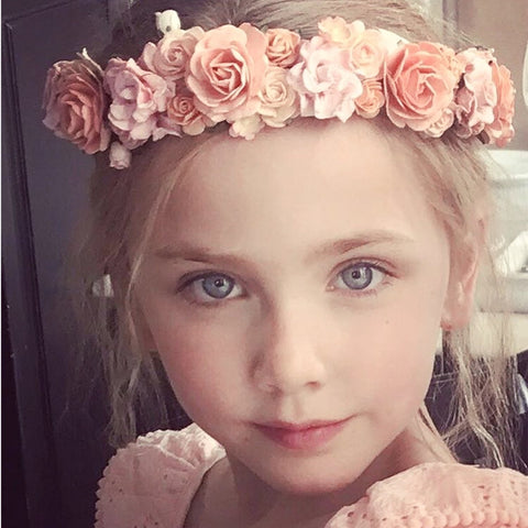 Flower girl hair pieces -Young girl wearing The Rose Bud Flower Crown, a handcrafted apricot floral hair wreath perfect for weddings and special occasions.